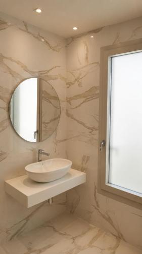 a bathroom with a sink and a mirror at Appartamento Doglio Lux in Cagliari