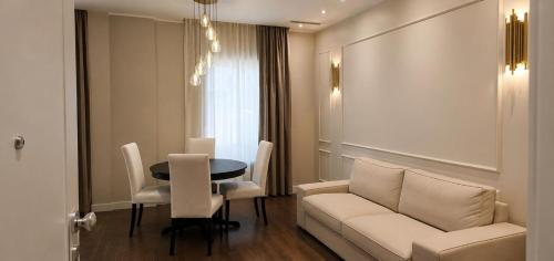 a living room with a couch and a table at Appartamento Doglio Lux in Cagliari