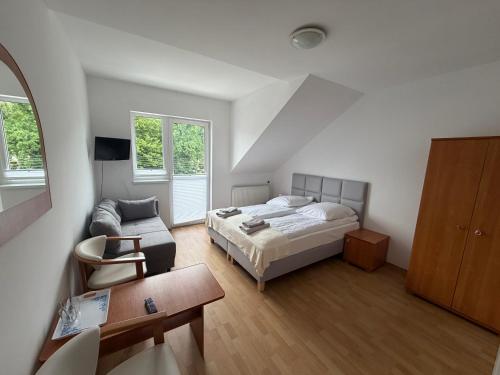 a bedroom with a bed and a couch at Tedi 2 in Rewal