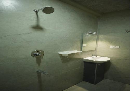 a bathroom with a sink and a mirror at DEVATA SUITES in Vijayawāda