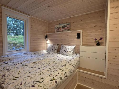 a bedroom with a bed in a log cabin at Lyckebo in Tyresö