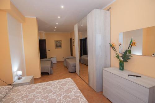 a living room with a bed and a mirror at Il Falco del Cilento in Torchiara