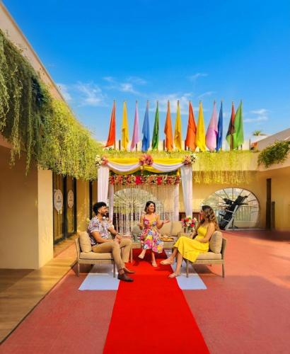 a group of people sitting on a red carpet at Grand Mostafa Hotel in Sylhet