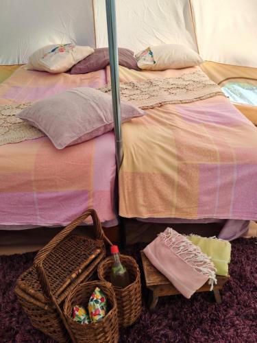 a bedroom with two beds with baskets on the floor at Torpakka glamping in Mikkeli
