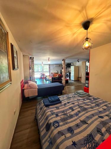 a bedroom with a bed and a living room at A casa di Lele a CAPALBIO in Capalbio