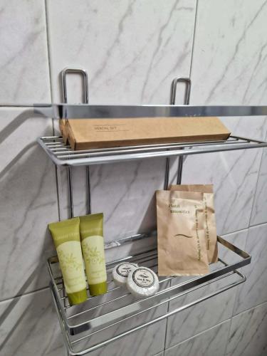 a metal shelf with a box and a bag on it at Olimpus Sunset Studio in Paralia Katerinis