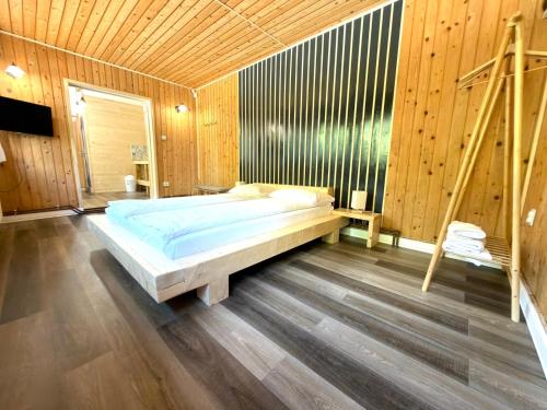 a bedroom with a bed in a wooden room at Cabana Plai in Petroşani