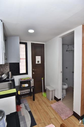 a kitchen with a sink and a toilet in a room at Apartment MJ in Olongapo