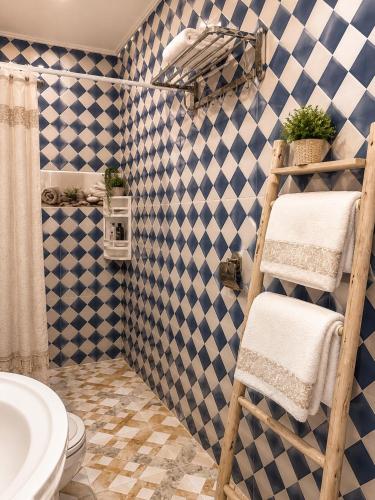 a bathroom with a blue and white tiled wall at Cozy Guesthouse in Aourir near Tamraght in Aourir