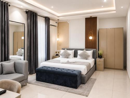 a bedroom with a large bed and a couch at NO 5 Hotel in Lekki