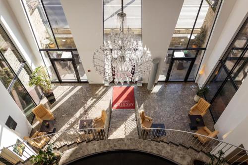 an overhead view of a lobby with a chandelier at ARCOTEL Camino Stuttgart in Stuttgart