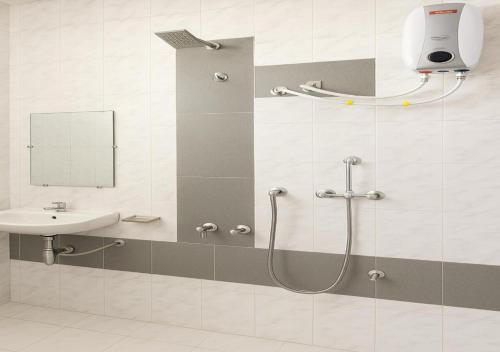 a bathroom with a shower and a sink at Hotel yogeshwar in Mahesāna