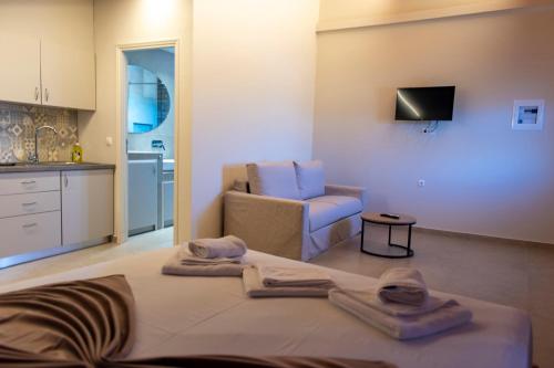 a room with a bed and a couch and a kitchen at PERDIKA's HORIZON in Perdika