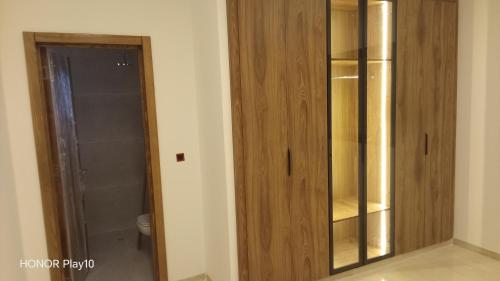 a bathroom with a wooden cabinet and a toilet at Elin house in Hammamet