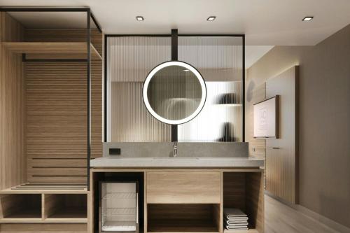 a bathroom with a sink and a mirror at AC Hotel by Marriott Denver RiNo in Denver
