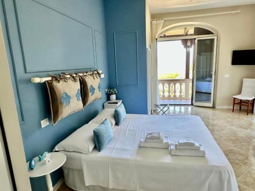 a bedroom with a large bed with blue walls at Villa Antonietta Ischia in Forio d'Ischia