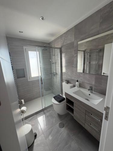 a bathroom with a toilet and a sink and a shower at Beautiful 3 bed villa on Mar Menor golf resort in Torre-Pacheco