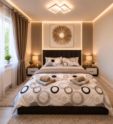 a bedroom with a large bed with two pillows at Apartament Rovine in Craiova