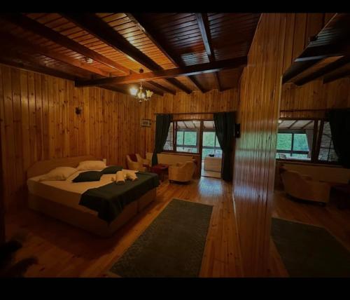 a bedroom with a bed and a living room at Özde Dağ Evi in Sapanca