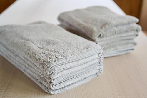three stacks of towels sitting on a table at Kokonimo Kawagoesenba in Kawagoe