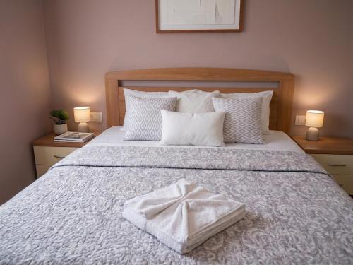 a bed with a white towel on top of it at Studio apartman Olivera in Rovinj