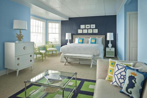 a bedroom with a bed and a couch and a table at The Tides Beach Club in Kennebunkport