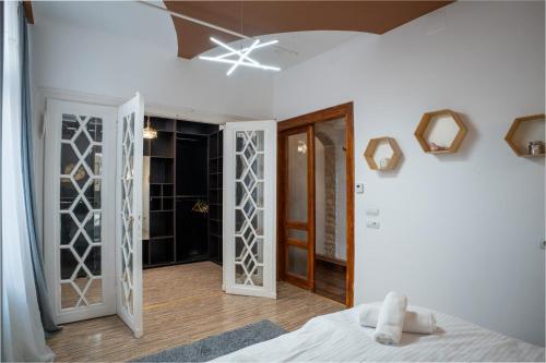 a bedroom with white walls and a bed in a room at Barrique 13 - Breakfast at Restaurant & Minibar - Old Town in Braşov