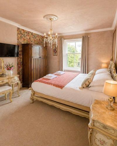 a bedroom with a large bed and a window at The Stables in Market Rasen