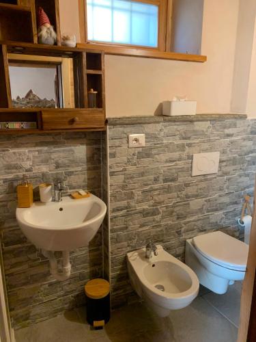 a bathroom with a sink and a toilet at El Torch di Long Elisa in San Garmano Chisone