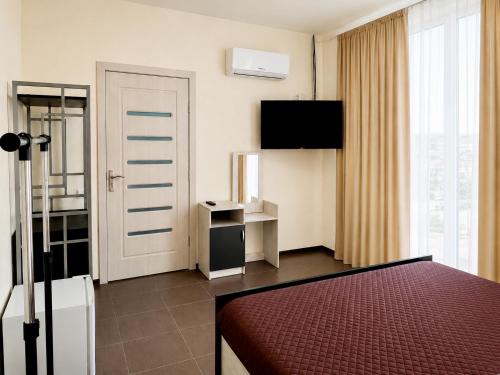 a hotel room with a bed and a door at Qzone 2 in Chornomorsk
