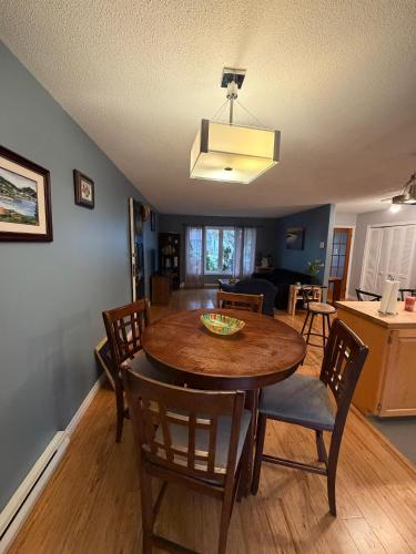 a dining room and living room with a table and chairs at Urban Midtown Stays in St. John's