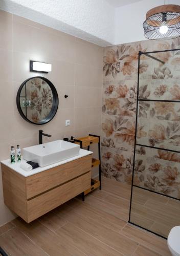 a bathroom with a sink and a mirror at Linovrochi holiday house with private pool in Lefkandi Chalkidas