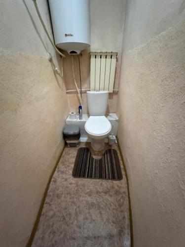 a small bathroom with a toilet in a room at House on the mountain in Ustʼ-Kamenogorsk