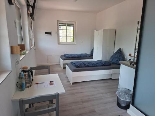 a small living room with a couch and a table at Unseburger-Brauhaus GmbH, FW 10 in Unseburg