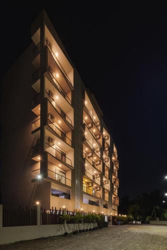 a large building with lights on it at night at Abhibha Suites Waterfront in Pune