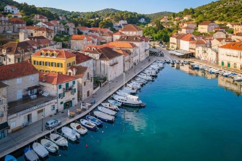 an aerial view of a town with boats in a harbor at Palazzo Viridis Heritage Hotel in Milna