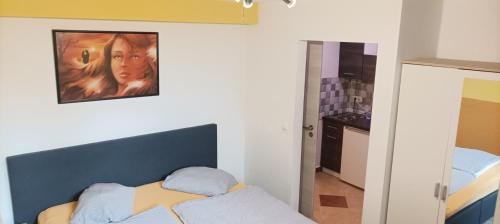 a bedroom with a bed and a painting on the wall at Pension Johnnys in Görlitz