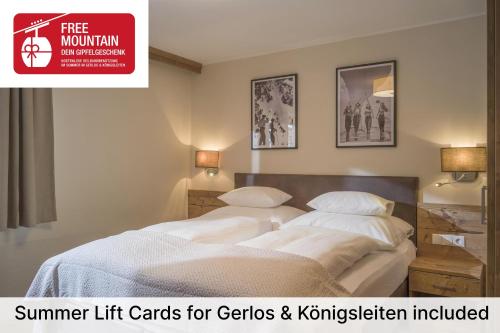 two beds in a hotel room with a sign that reads summer lift cards for g at Apartment Gerlos 183 in Gerlos