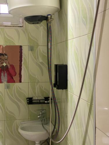 a bathroom with a sink and a toilet at Silk Way in Ureki