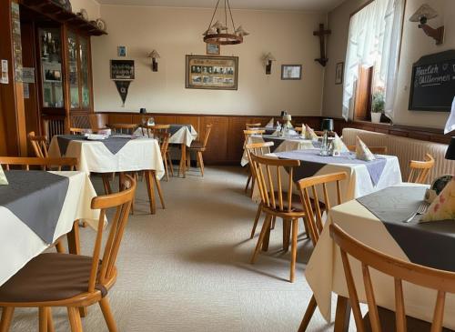 a dining room filled with tables and chairs at Bayerischer Hof in Amorbach