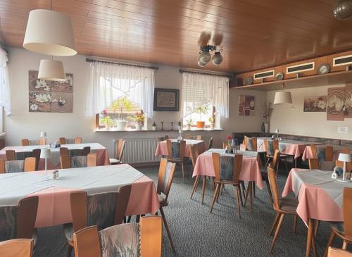 a restaurant with tables and chairs in a room at Bayerischer Hof in Amorbach