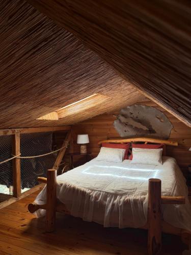 a bedroom with a bed in a log cabin at Lilaste in Lilaste