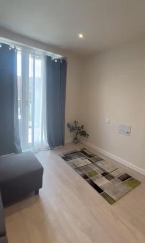 a living room with a couch and a rug at Harrow Nest - 1Bedroom in Hatch End