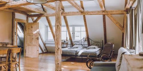 a bedroom with a bed in a room with wooden beams at Dom Sokolik in Trzcińsko
