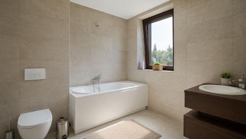 a bathroom with a tub and a toilet and a sink at TIAM Apartment Poiana Brașov D117, 3 rooms, 3 terraces, 3 bathrooms in Poiana Brasov