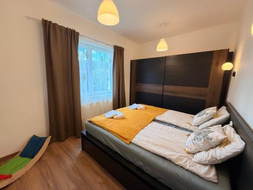 a bedroom with a large bed and a window at Balaton Breeze in Balatonalmádi