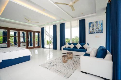 a bedroom with a bed and a couch at Monara Villa in Dharga Town