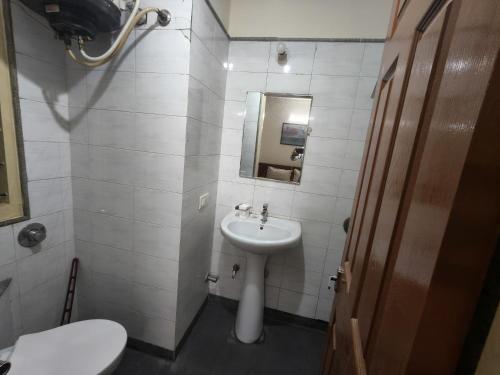 a small bathroom with a sink and a toilet at 2bhk furnished Richmond town in Bangalore
