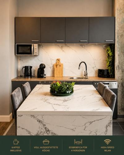 a kitchen with a table with a counter top at Aue Stay in Kassel