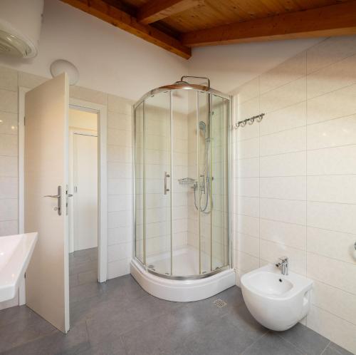 a bathroom with a shower and a toilet and a sink at Holiday Home Nevera in Kaštela